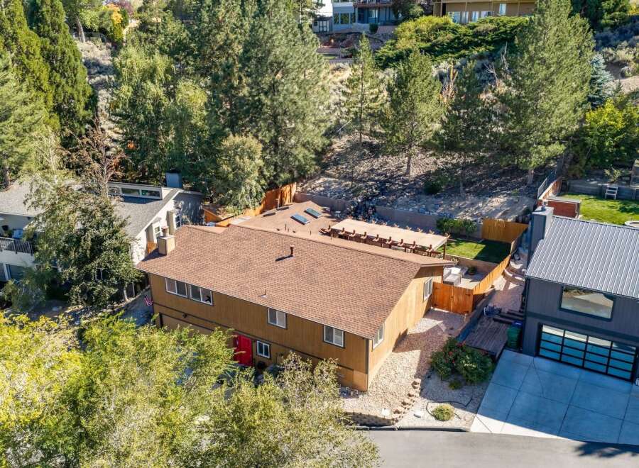 Discover this charming home nestled amongst mature trees, offering a serene and private setting.