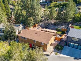 Discover this charming home nestled amongst mature trees, offering a serene and private setting.