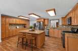 Step into this beautifully updated kitchen, featuring warm cherry wood cabinets and granite countertops that exude elegance.