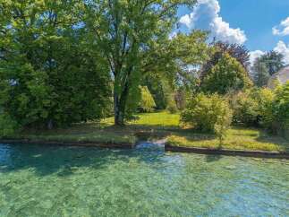 Experience serene waterfront living with this stunning property, boasting crystal-clear turquoise waters perfect for swimming or boating.