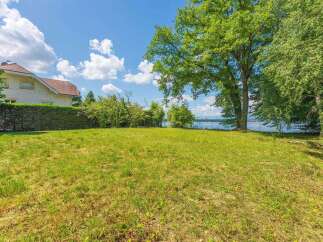 Discover this stunning property with a spacious green lawn, perfect for outdoor activities and relaxation.