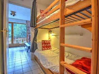 This charming room features a cozy bunk bed setup, perfect for families or groups.