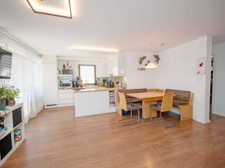 Experience modern living in this open-concept space, seamlessly blending a stylish kitchen with a comfortable dining area.