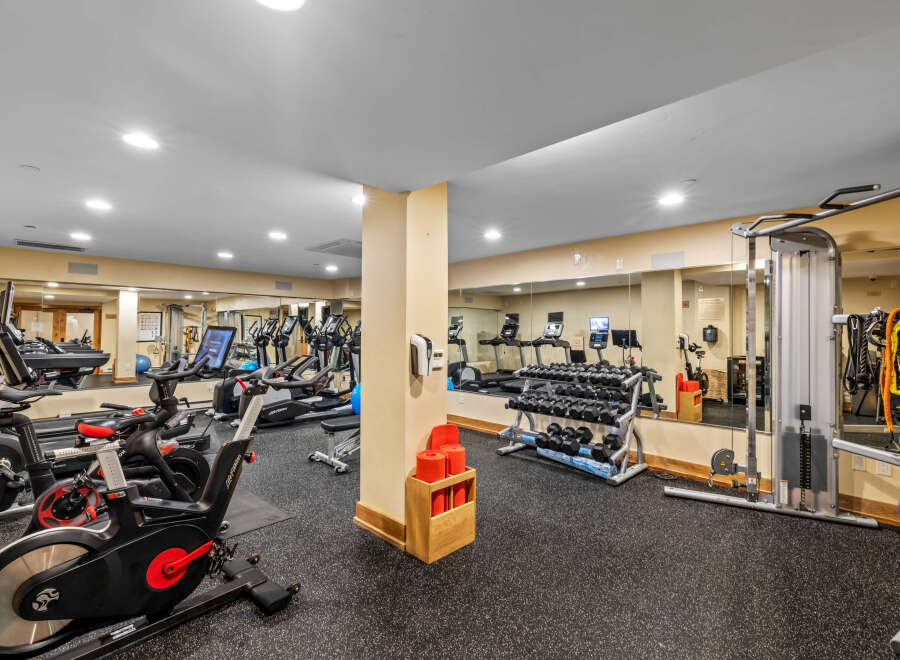 This well-equipped gym features a variety of cardio machines, including treadmills and stationary bikes, perfect for your daily workout.