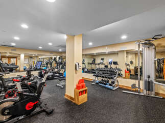 This well-equipped gym features a variety of cardio machines, including treadmills and stationary bikes, perfect for your daily workout.