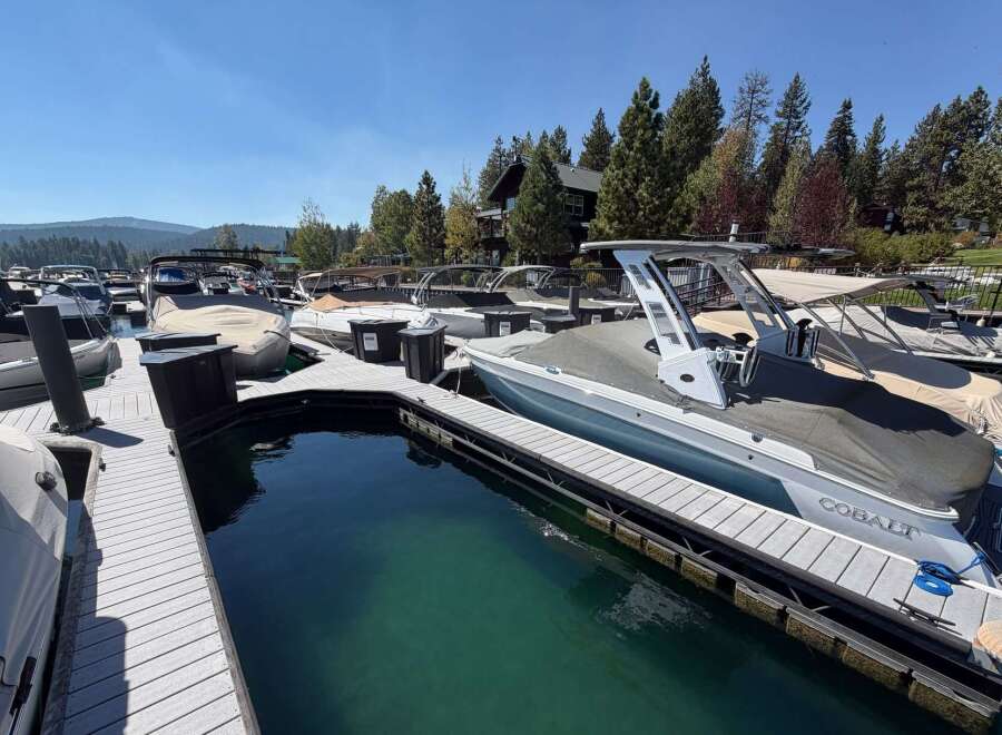 Experience lakeside luxury with this stunning property featuring a private dock and multiple boat slips, perfect for water enthusiasts.