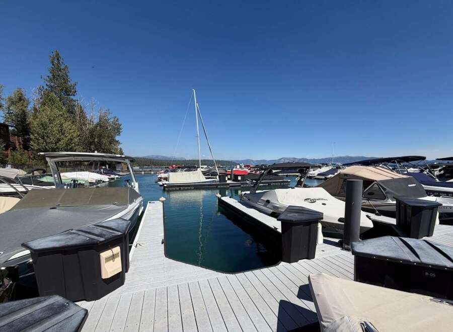 Experience lakeside living at its finest with this stunning marina view, featuring a collection of well-maintained boats docked and ready for adventure.
