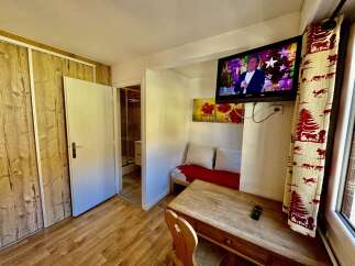 This cozy room features a charming wooden desk and chair, perfect for work or relaxation.