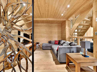 Experience rustic charm in this stunning wooden cabin living room, featuring a plush sectional sofa perfect for cozy evenings.