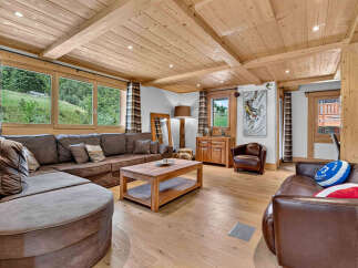 Experience rustic charm and modern comfort in this inviting living room, featuring a spacious sectional sofa and a warm wooden coffee table.
