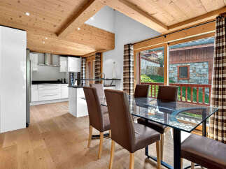 Experience modern living in this stunning property featuring a sleek, white kitchen with ample cabinet space and a stylish island.