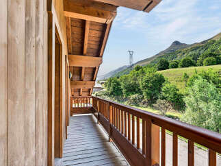Experience breathtaking mountain views from this charming wooden balcony, perfect for enjoying your morning coffee or evening relaxation.