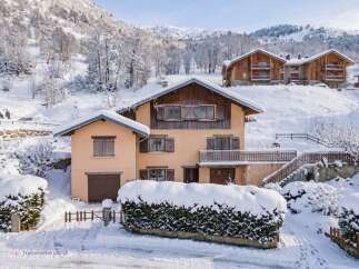 Experience the charm of a winter wonderland with this picturesque property nestled in a snowy mountain landscape.