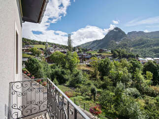 Experience breathtaking mountain views from this charming property, featuring a picturesque village nestled in the valley below.