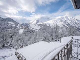 Experience the magic of winter from this stunning property, offering breathtaking panoramic views of snow-capped mountains and a charming alpine village nestled in the valley.