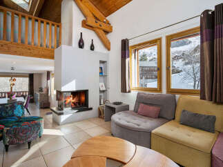 Experience cozy living in this charming mountain retreat, featuring a modern fireplace as the centerpiece of the living area.