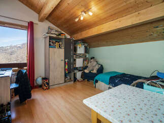 Discover this charming attic bedroom, perfect for a cozy retreat.