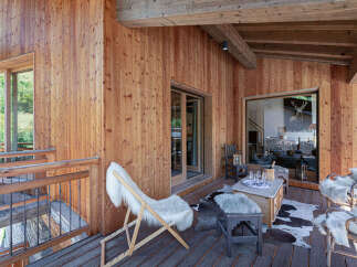 Experience rustic luxury on this charming wooden balcony, perfect for enjoying the mountain air.