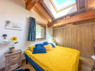 Experience cozy mountain living in this charming bedroom featuring a bright yellow duvet and plush blue and yellow accent pillows.