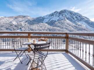 Experience breathtaking mountain views from this charming balcony, perfect for enjoying a morning coffee or evening tea.