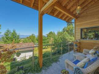 Enjoy breathtaking panoramic views from this charming wooden balcony, perfect for relaxing or entertaining.