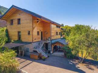 Discover this charming wooden house nestled amidst lush greenery, offering a serene retreat.