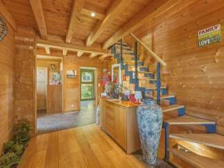 Experience rustic charm in this wooden-clad home featuring a unique spiral staircase with blue accents.