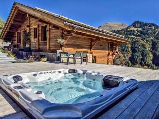 Experience ultimate relaxation in this stunning mountain retreat, featuring a luxurious hot tub with breathtaking panoramic views.