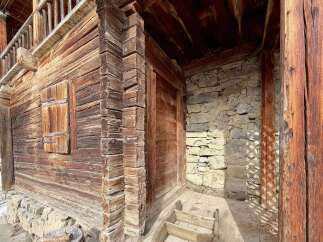 Discover rustic charm in this historic wooden cabin, featuring a traditional log construction and a stone foundation.