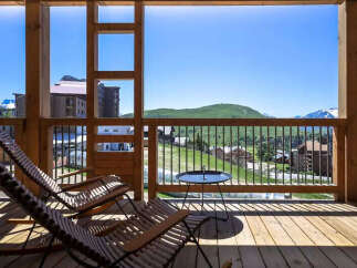 Enjoy breathtaking mountain views from this charming balcony, perfect for relaxing with a morning coffee or evening drink.