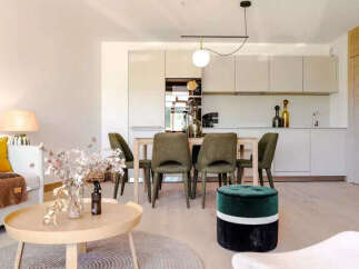Discover modern living in this beautifully appointed open-concept space, featuring a sleek kitchen with ample cabinetry and a stylish dining area perfect for entertaining.