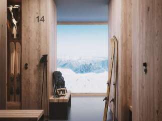 Experience luxury mountain living with this ski locker room, featuring individual wooden lockers and stunning panoramic views of snow-capped peaks.