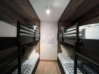 Experience ultimate comfort and style in this ski-themed bunk room, perfect for families or groups.