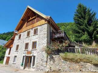 Discover this charming stone house nestled in a serene mountain setting, perfect for a tranquil getaway.
