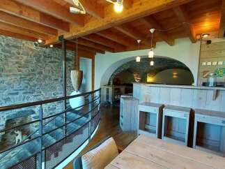 Discover this charming property featuring rustic stone walls and exposed wooden beams, creating a warm and inviting atmosphere.