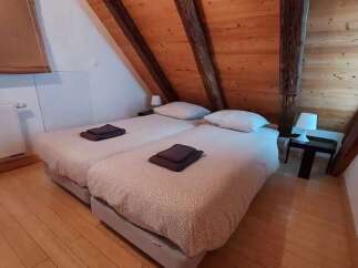 This charming attic bedroom features two comfortable twin beds, perfect for accommodating guests or family.