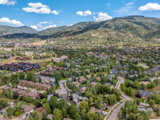 Discover this stunning mountain community offering a blend of modern townhomes and traditional single-family residences nestled amidst lush greenery.