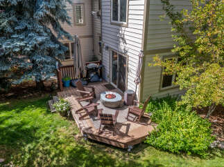 Enjoy outdoor living with this spacious deck featuring a fire pit and comfortable seating, perfect for gatherings.