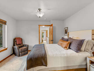 This inviting bedroom features a comfortable bed with plush pillows and a cozy throw blanket, perfect for relaxation.