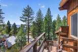 Experience breathtaking lake and mountain views from this charming wooden home, nestled amidst towering pine trees.