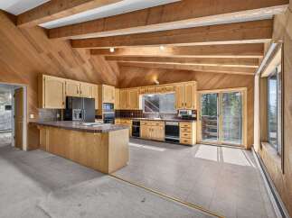 Discover a charming kitchen with rustic wooden beams and paneled walls, creating a warm and inviting atmosphere.