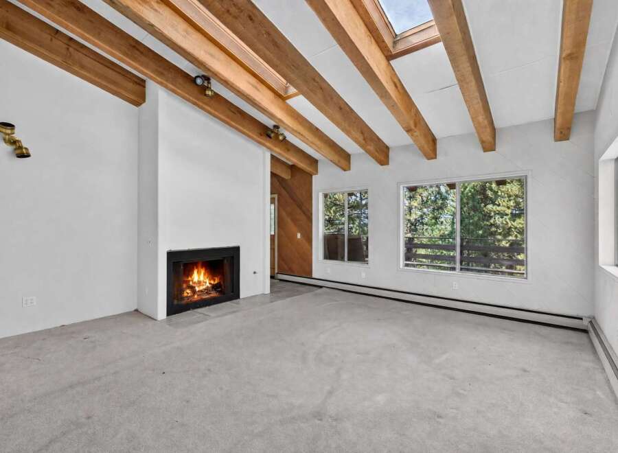 Experience the warmth and charm of this inviting living space, featuring a cozy fireplace perfect for chilly evenings.