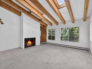 Experience the warmth and charm of this inviting living space, featuring a cozy fireplace perfect for chilly evenings.