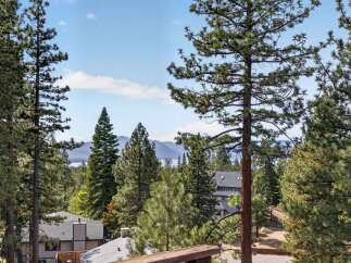 Experience breathtaking lake and mountain views from this stunning property, nestled amongst mature pine trees.