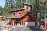 Nestled among tall pine trees, this rustic wooden home offers a unique mountain retreat.