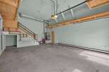 Discover the potential of this versatile garage space, featuring a convenient staircase leading to an upper level for added storage or workspace.
