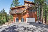 Nestled among tall pine trees, this rustic wooden home offers a unique architectural style with multiple levels and balconies.