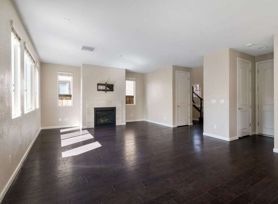 Step into this spacious living area featuring a modern fireplace as the focal point, perfect for cozy evenings.