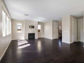 Step into this spacious living area featuring a modern fireplace as the focal point, perfect for cozy evenings.