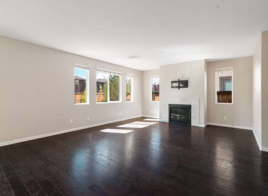 This spacious living room features a modern gas fireplace with a tile surround, perfect for cozy evenings.